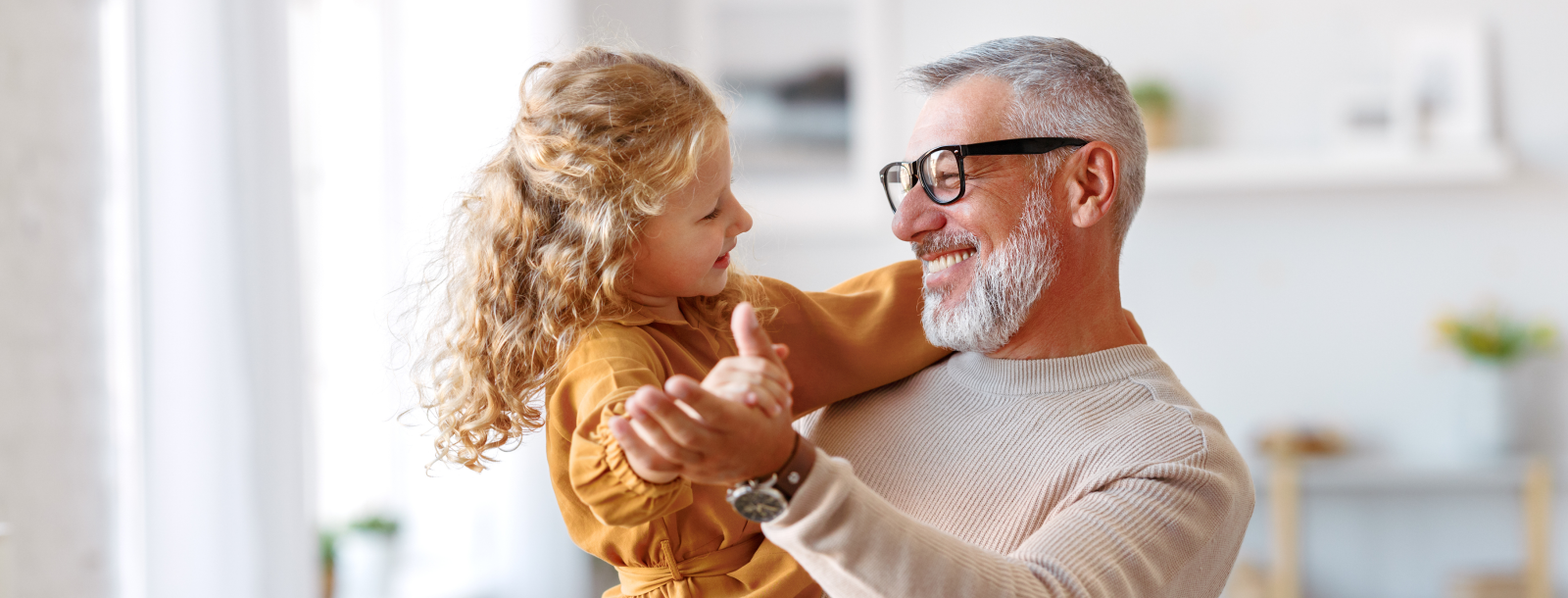 Grandfather dancing with granddaughter